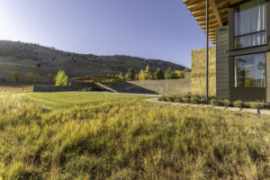 Outdoor landscape, relaxing chairs along with a beautiful sunrise view, plants, and trees